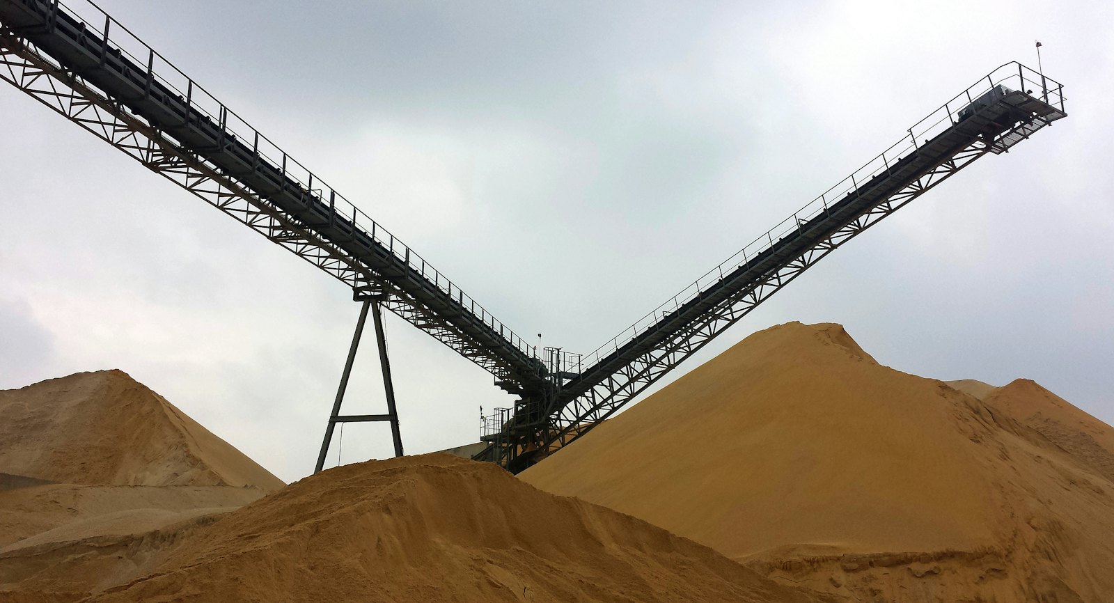 Heavy machinery working on open red ground in the Goldfields