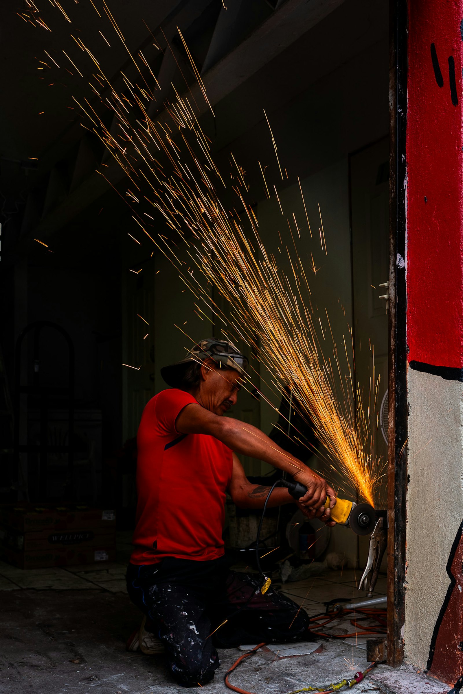 Mechanic using an angle grinder in a workshop
