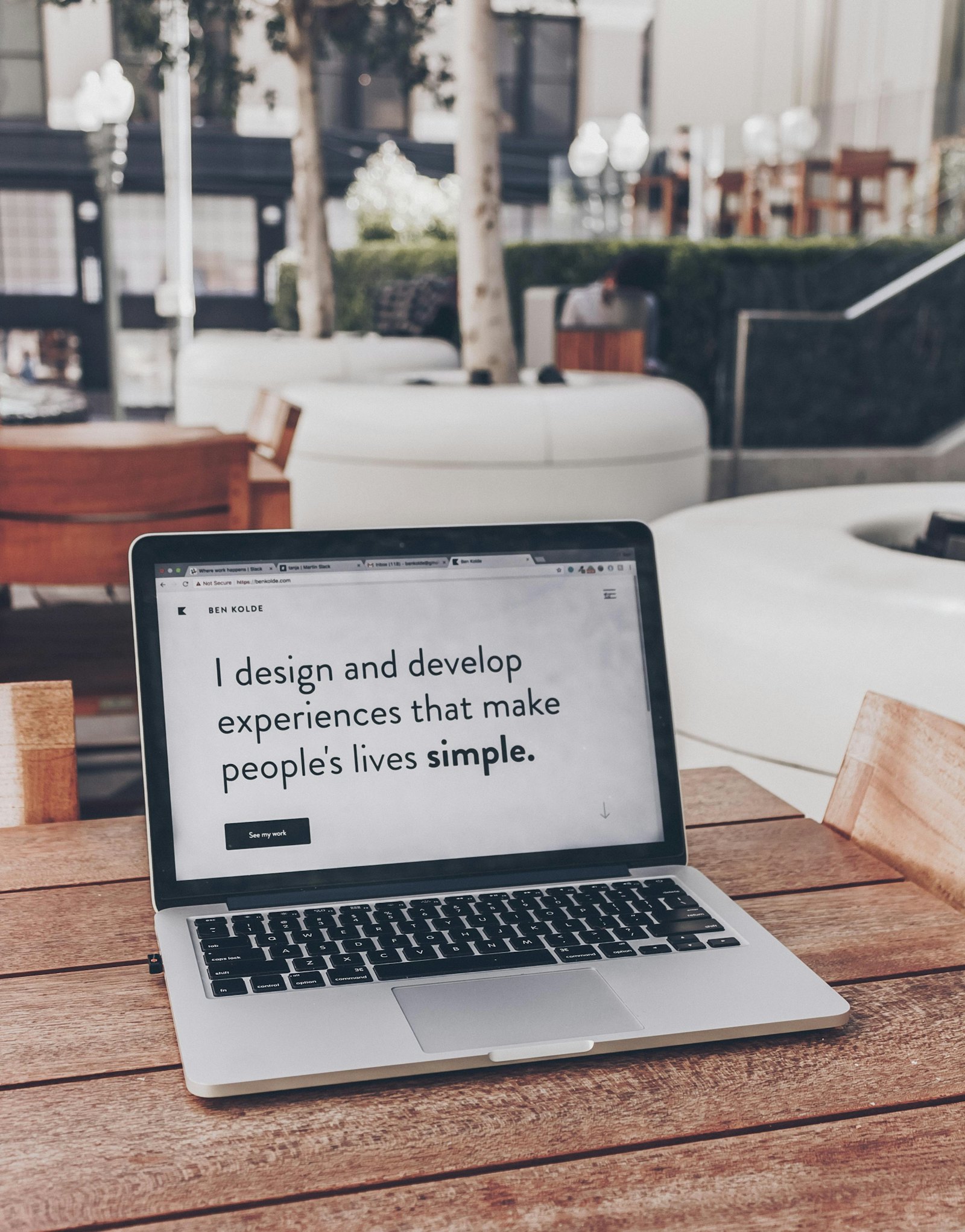 Laptop on a white desk showing a simple business website