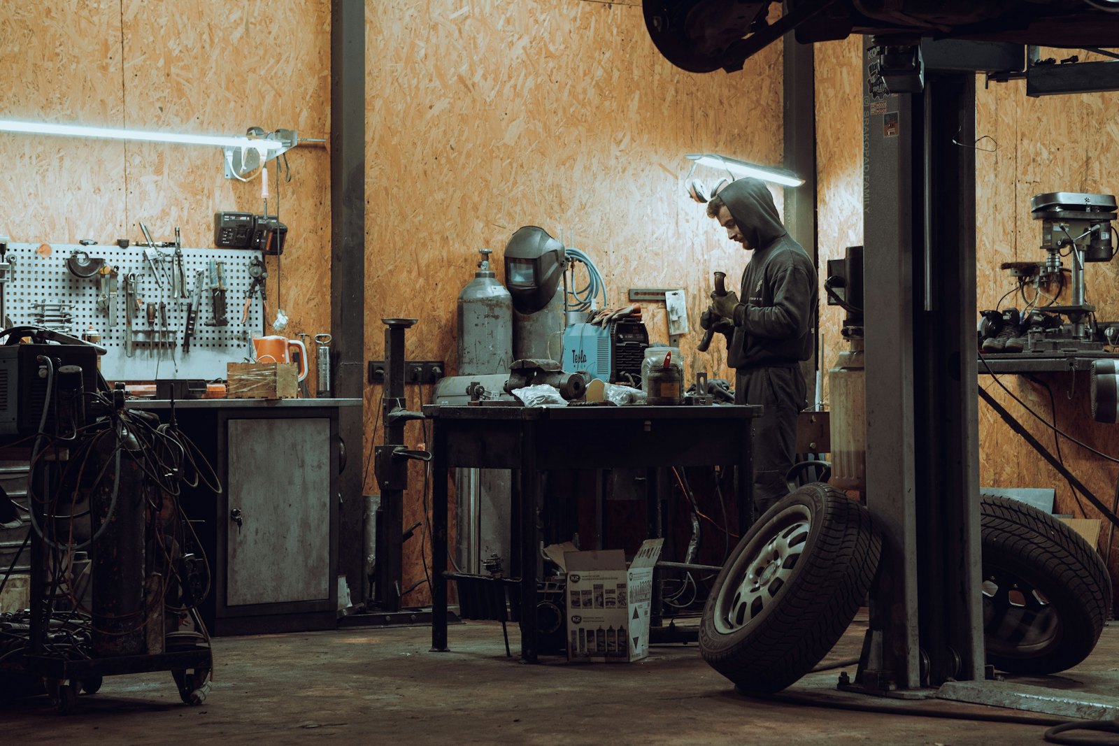 Mechanic working on a vehicle in a garage