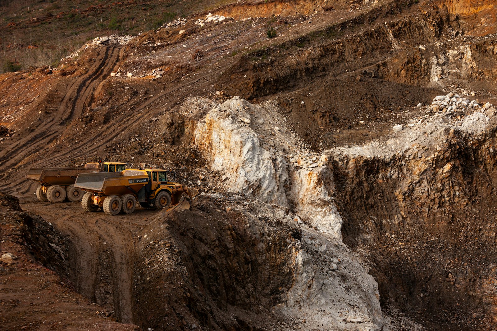 Large haul truck driving along a red dirt road