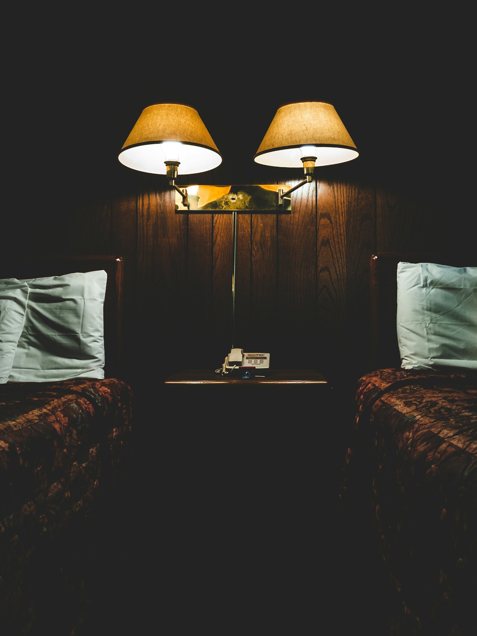 A neatly made bed in a motel room