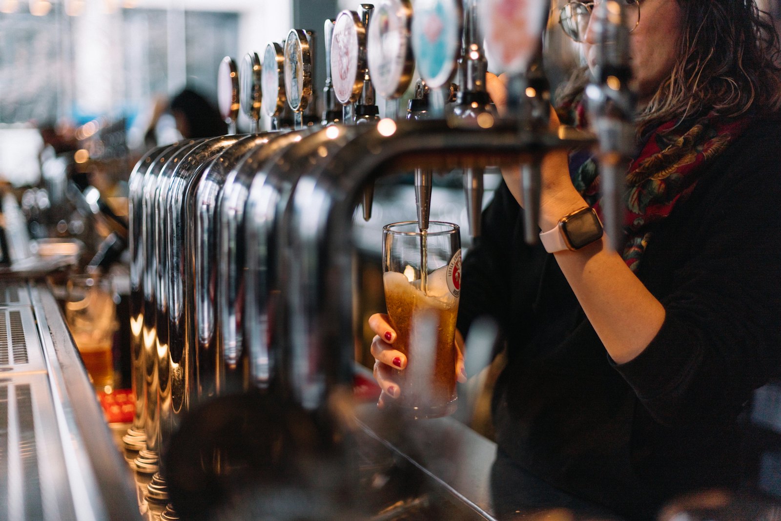 Bartender pouring a beer from a tap