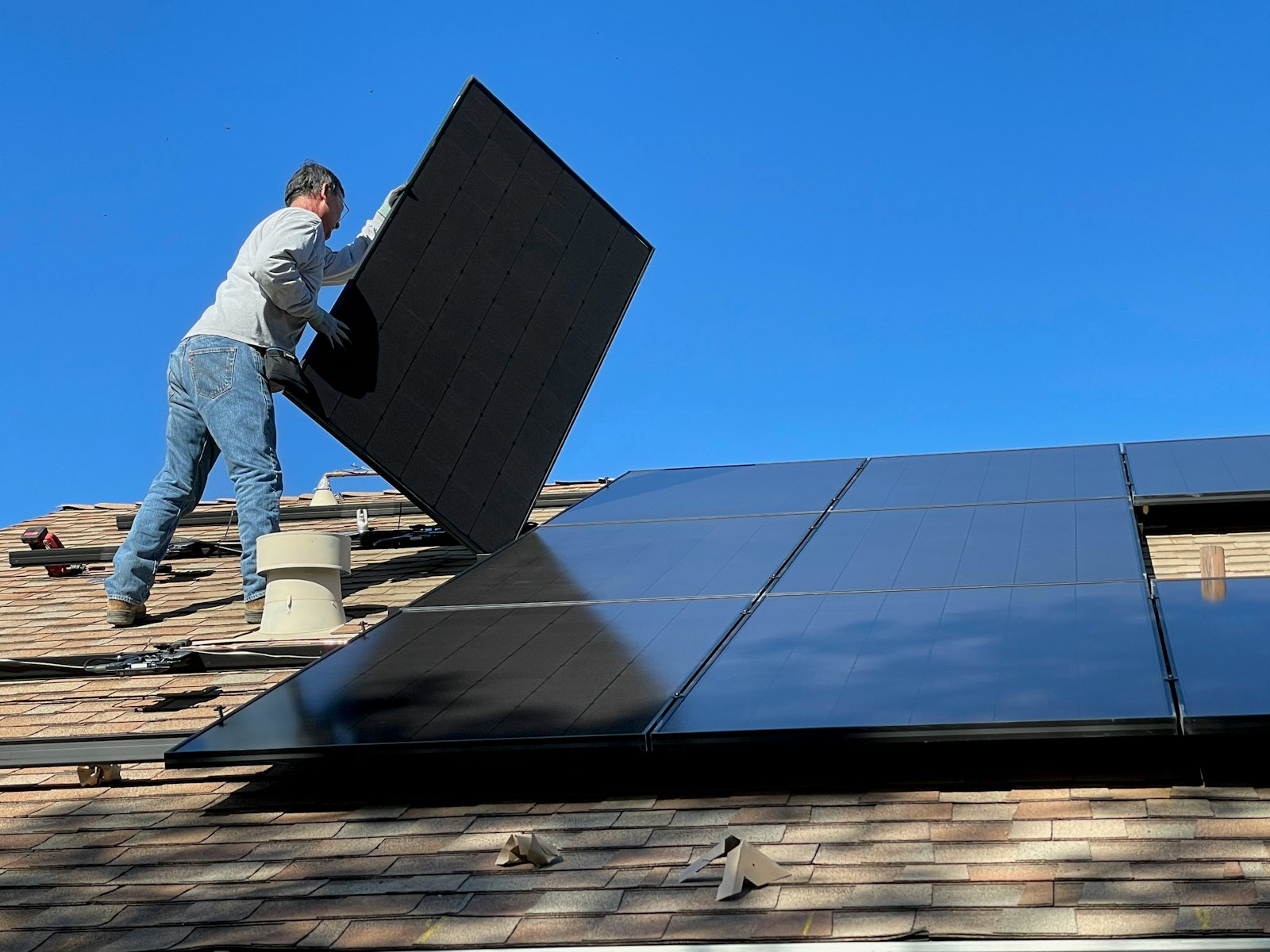 Solar panels being installed on a house roof
