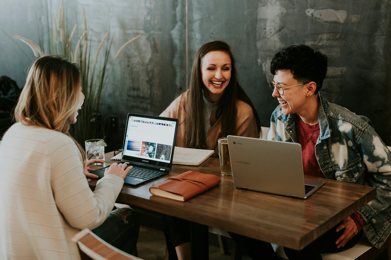 Small team reviewing information together on a laptop