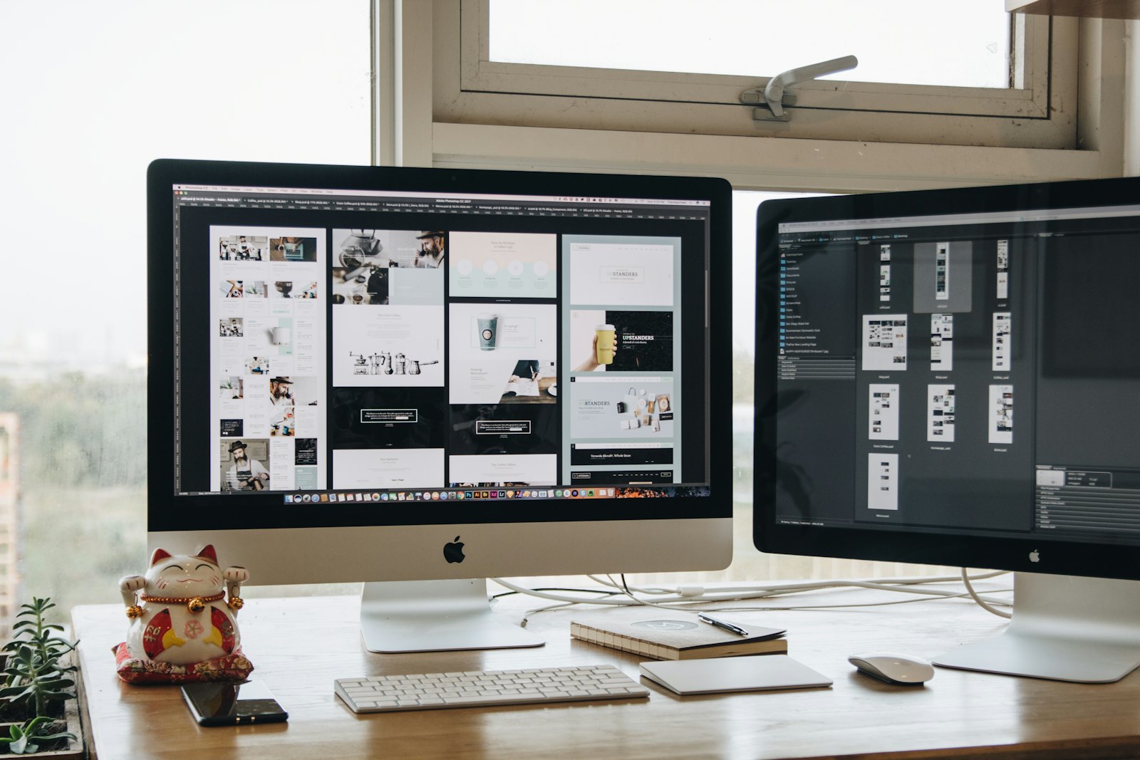 A web designer working across two computer screens
